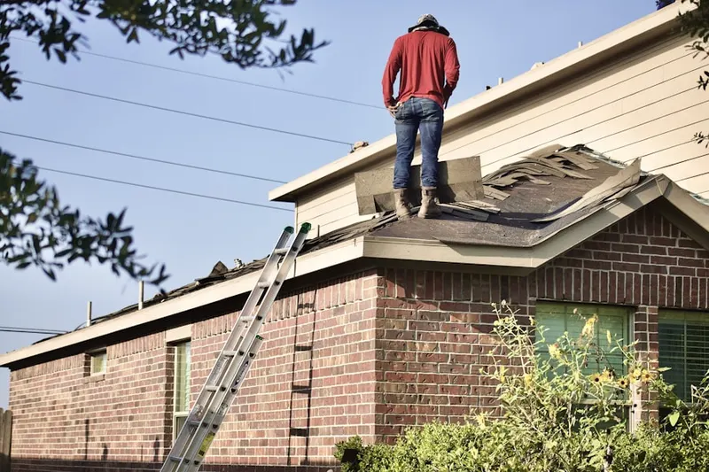 Professional roofer working on a residential roof in Douglas Byrd